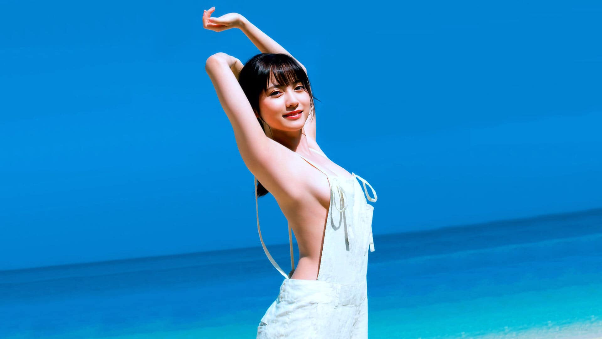 Alluring Asian brunette woman in a dress on a beautiful beach, a captivating and tasteful image.