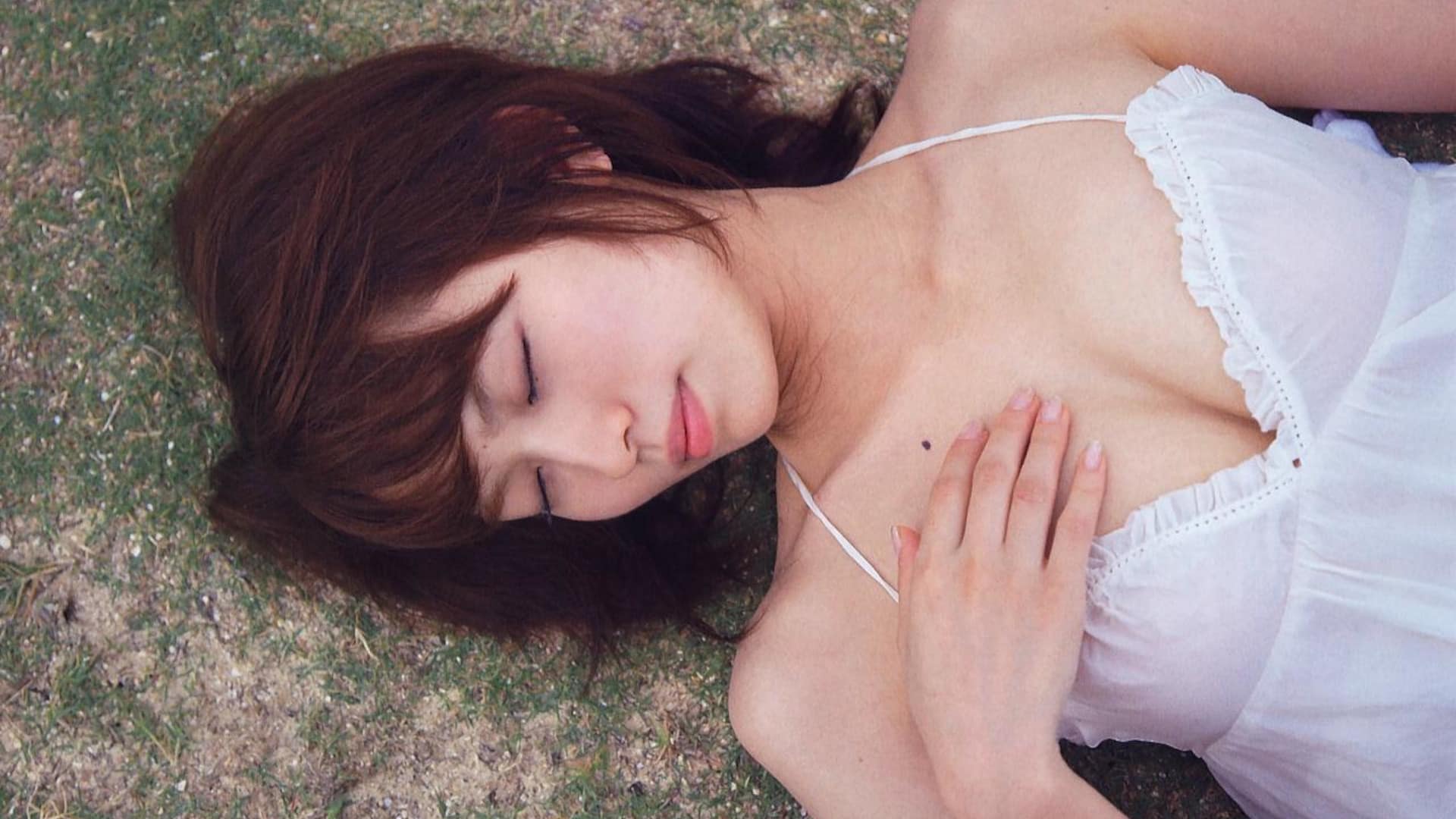 Captivating red-haired Asian woman in elegant lingerie outdoors, a beautiful and alluring scene.
