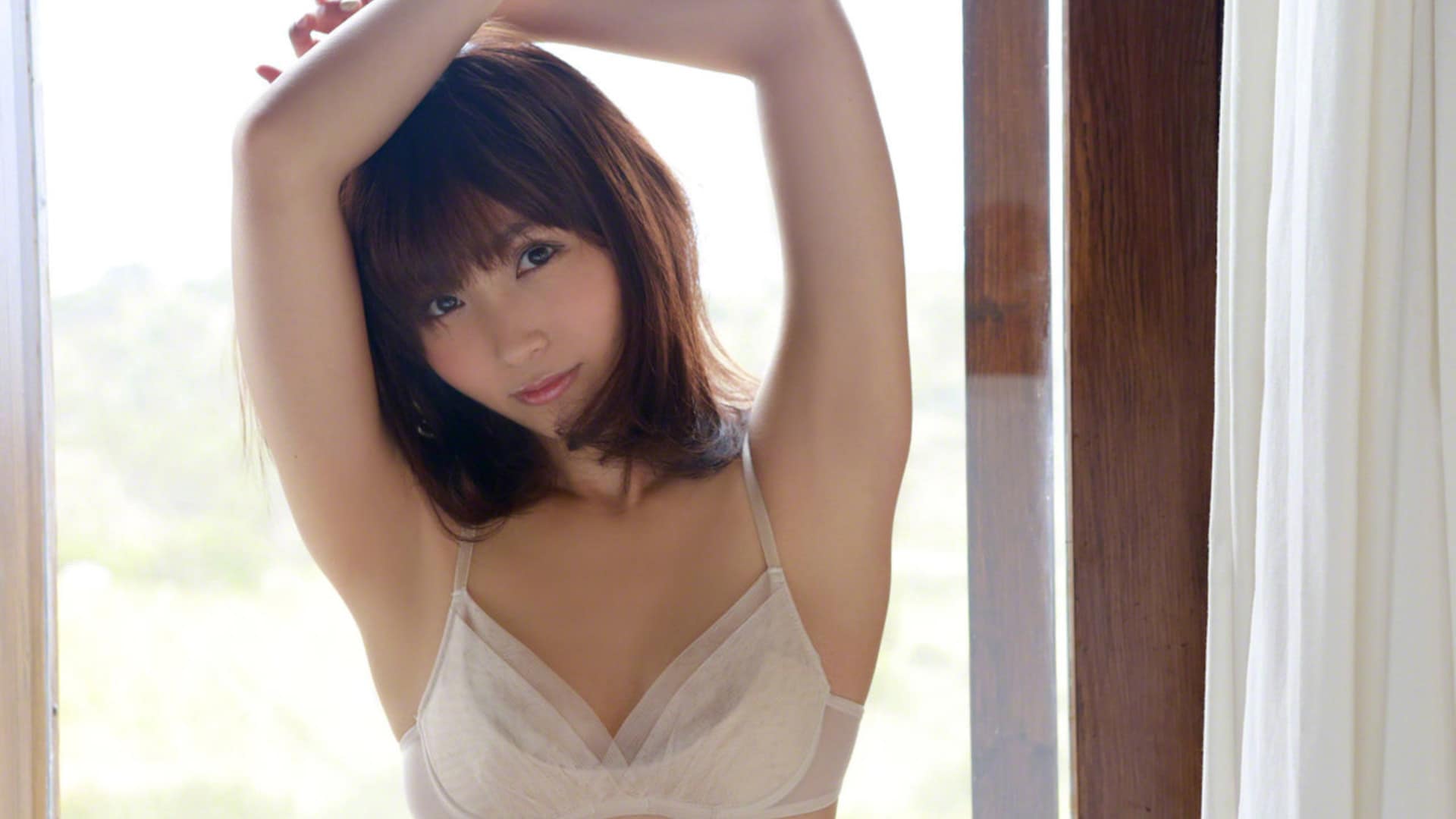 Beautiful Asian woman with red hair in lingerie by a window, alluring wallpaper.
