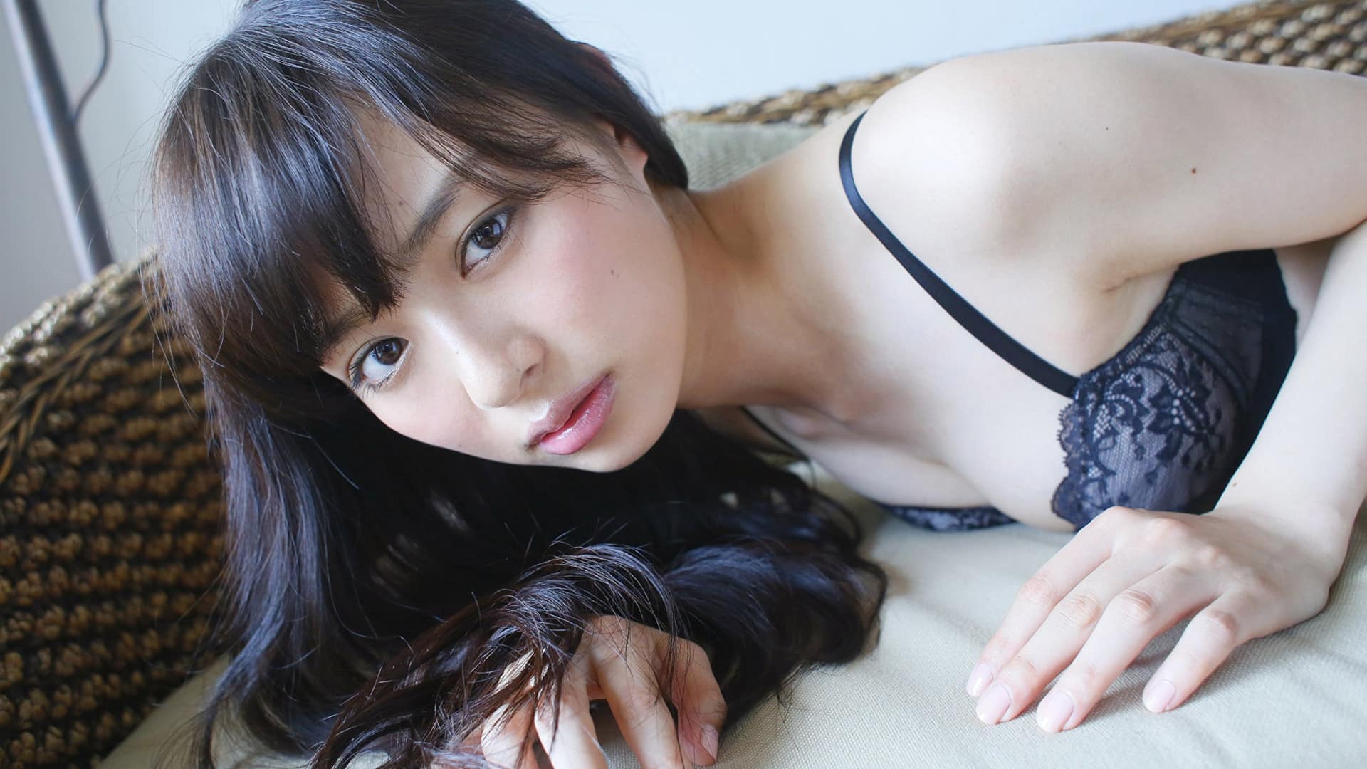 Asian brunette in elegant lingerie on bed. Perfect for a beautiful wallpaper.