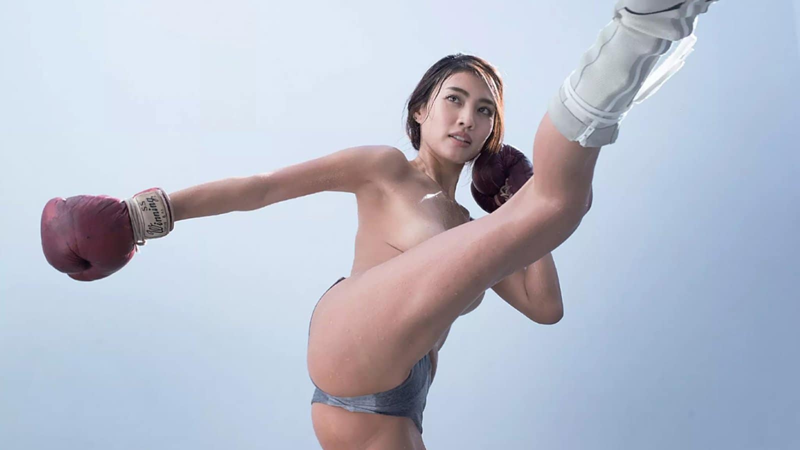 Alluring Asian brunette in fitness fashion in a stylish room setting.